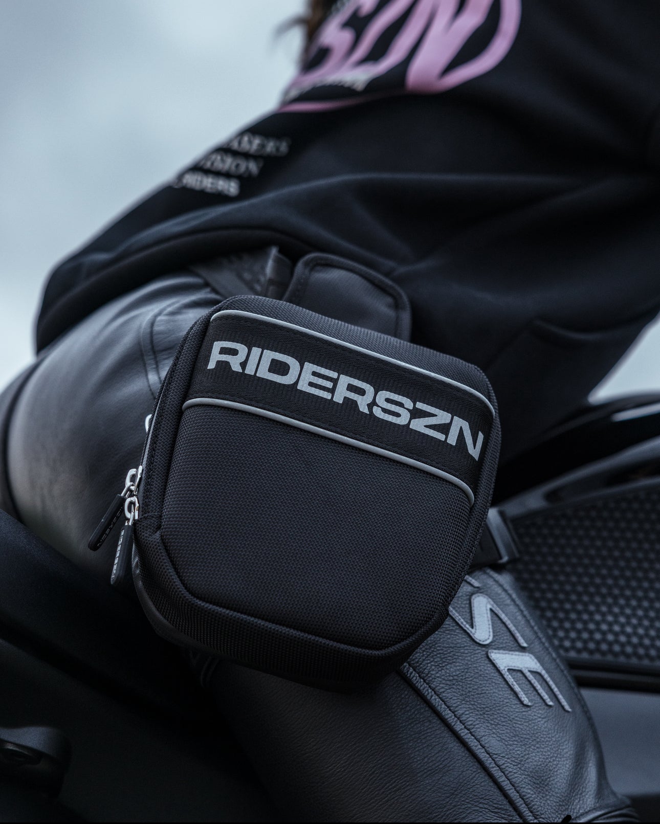 Rider wearing RIDER SZN leg bag. Close up 