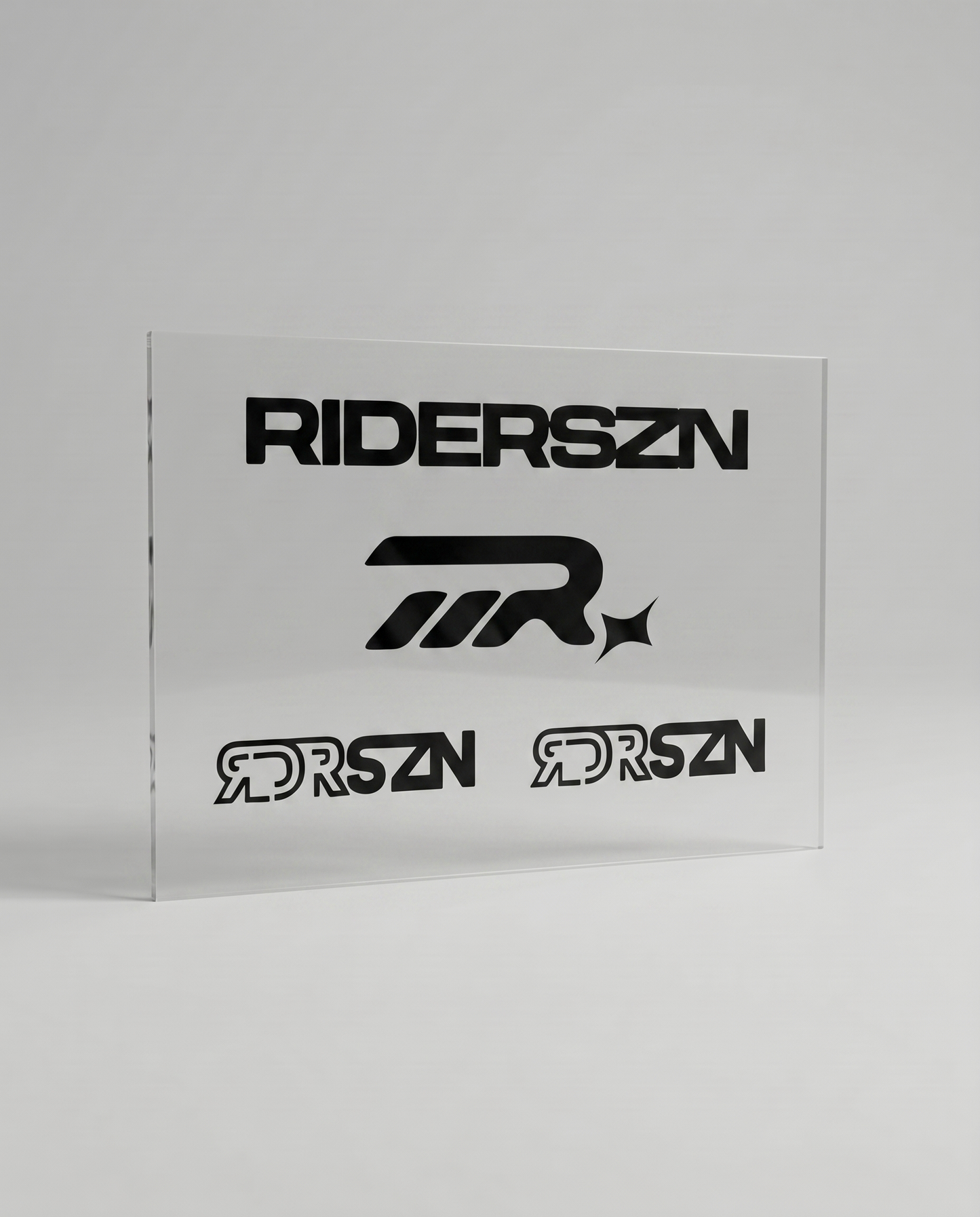 Clear acrylic sheet with black 'RIDERSZN' and RDRSZN logo on a gray background