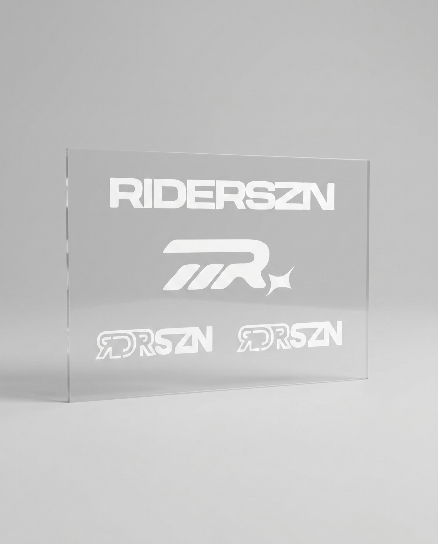 Clear acrylic panel with 'RIDERSZN' logo on a gray background
