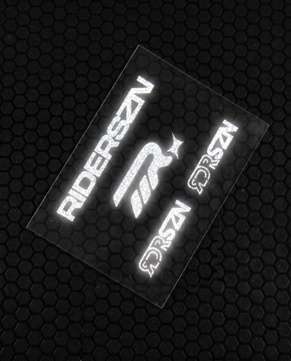 Reflective stickers with 'RIDERSZN' and RDRSZN logo on a textured black background