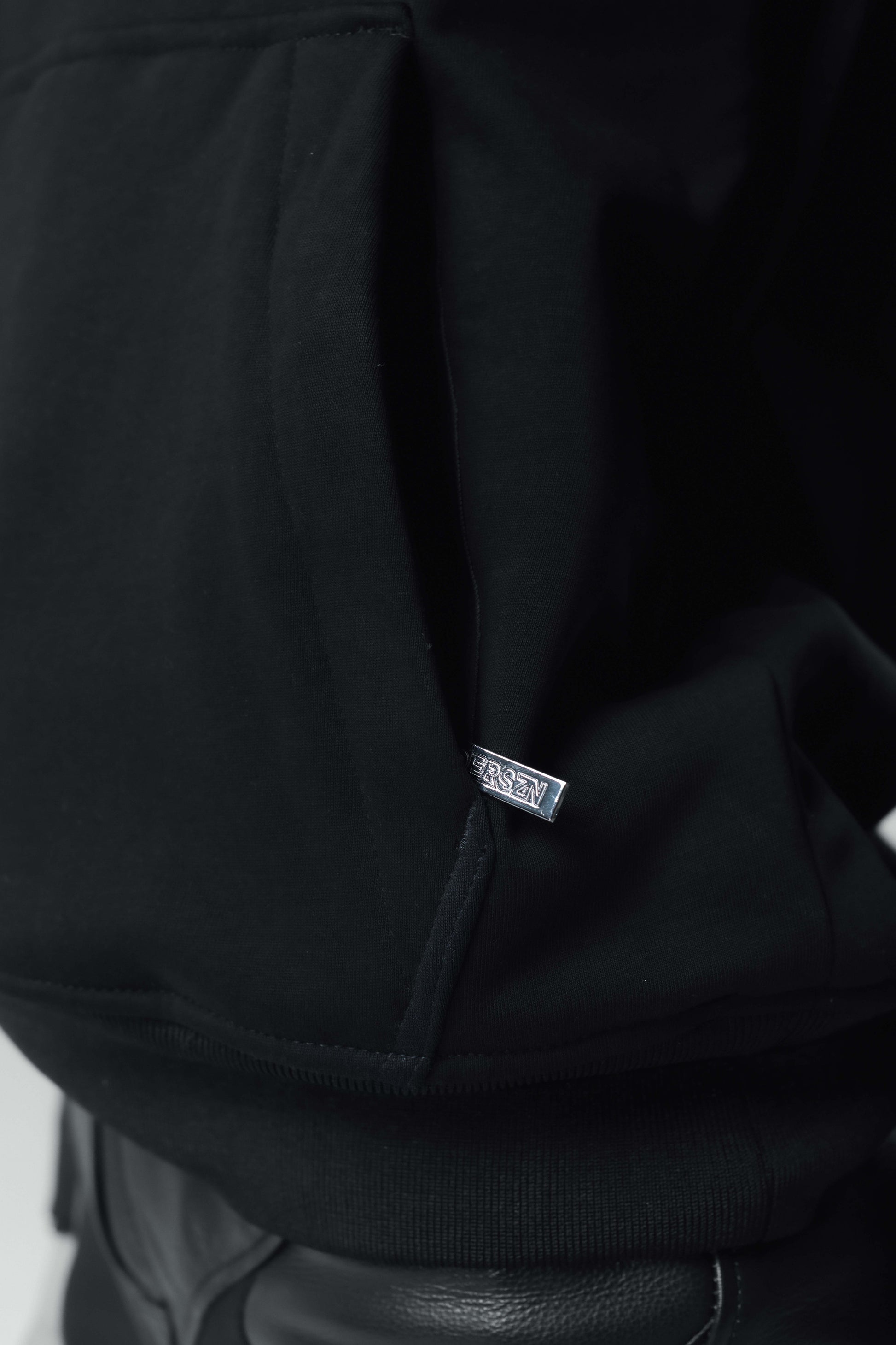 close up of armoured hoodie with metal zipper on pocket
