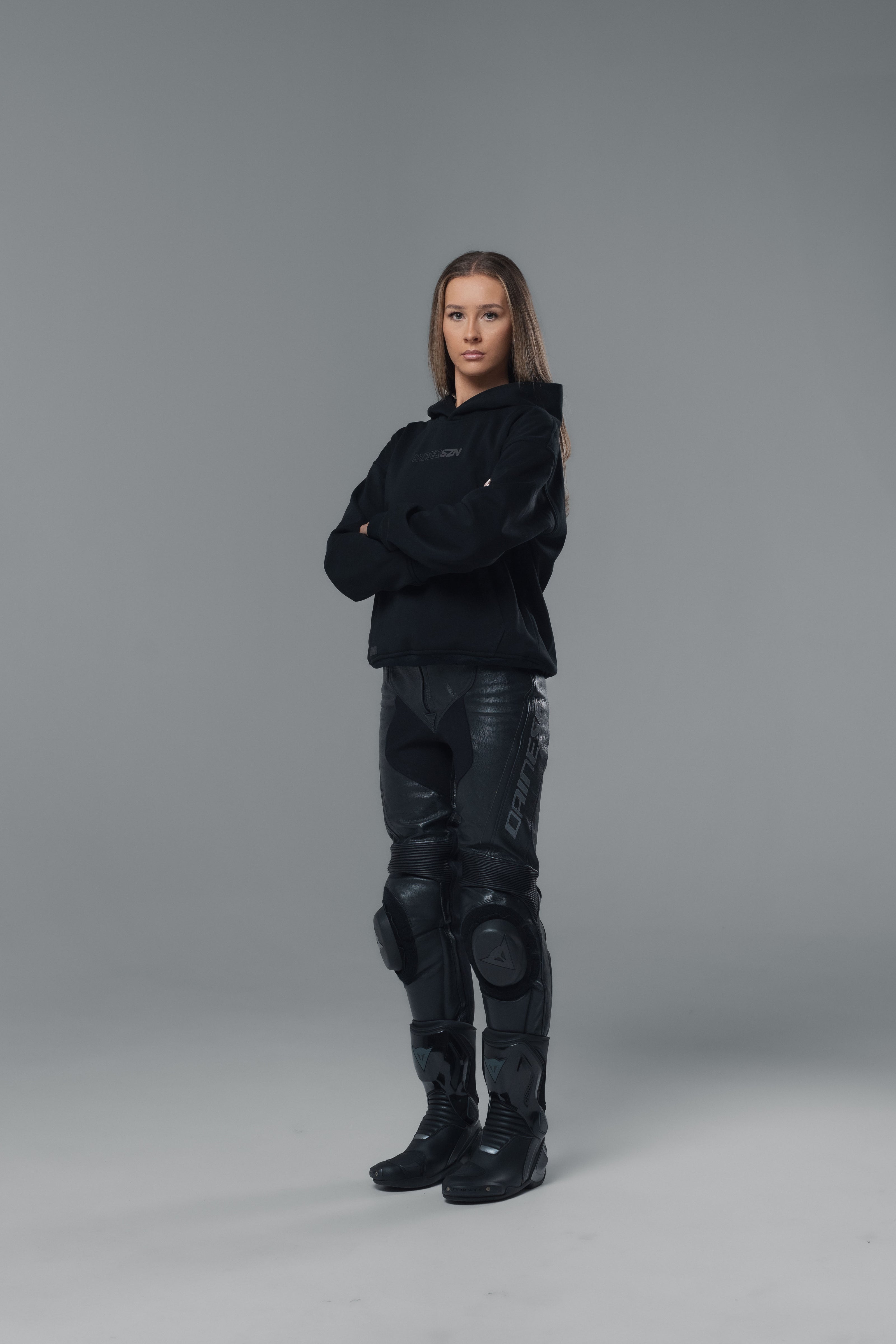 Female wearing black armoured hoodie with motorcycle leather pants