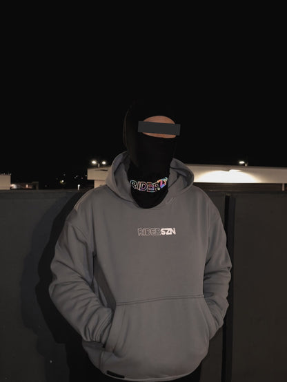 RiderSZN seamless reflective holographic balaclava worn with grey armoured hoodie with flash at night. 